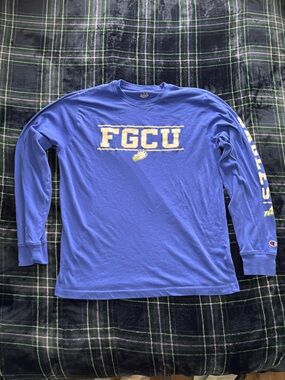 Champion blue long sleeve FGCU shirt with front and sleeve graphic. Size: L.
